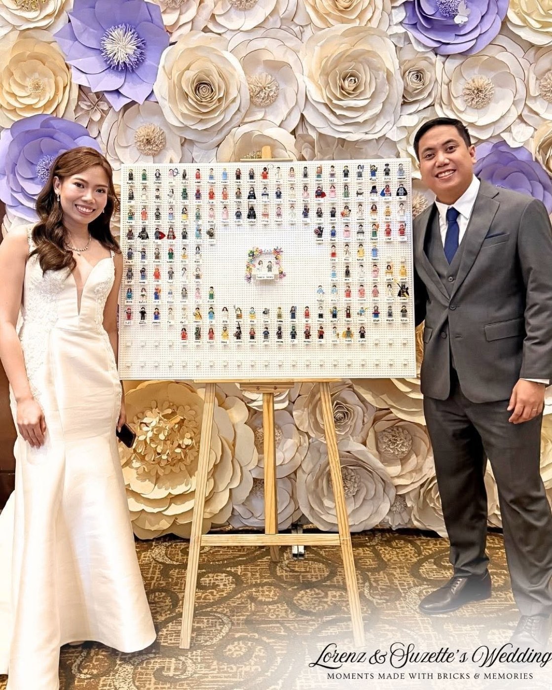 Couple beside a Bricks & Memories minifigure guestbook frame